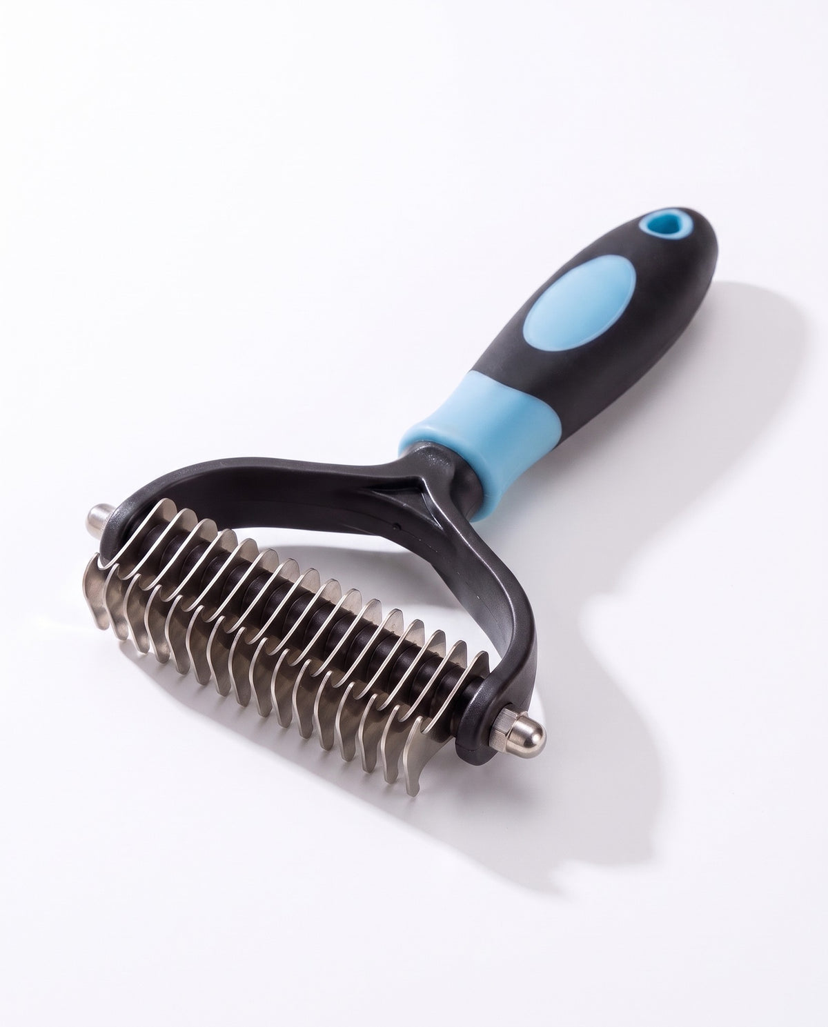 Two-Sided Dematting and Deshedding Rake, styled in a home setting