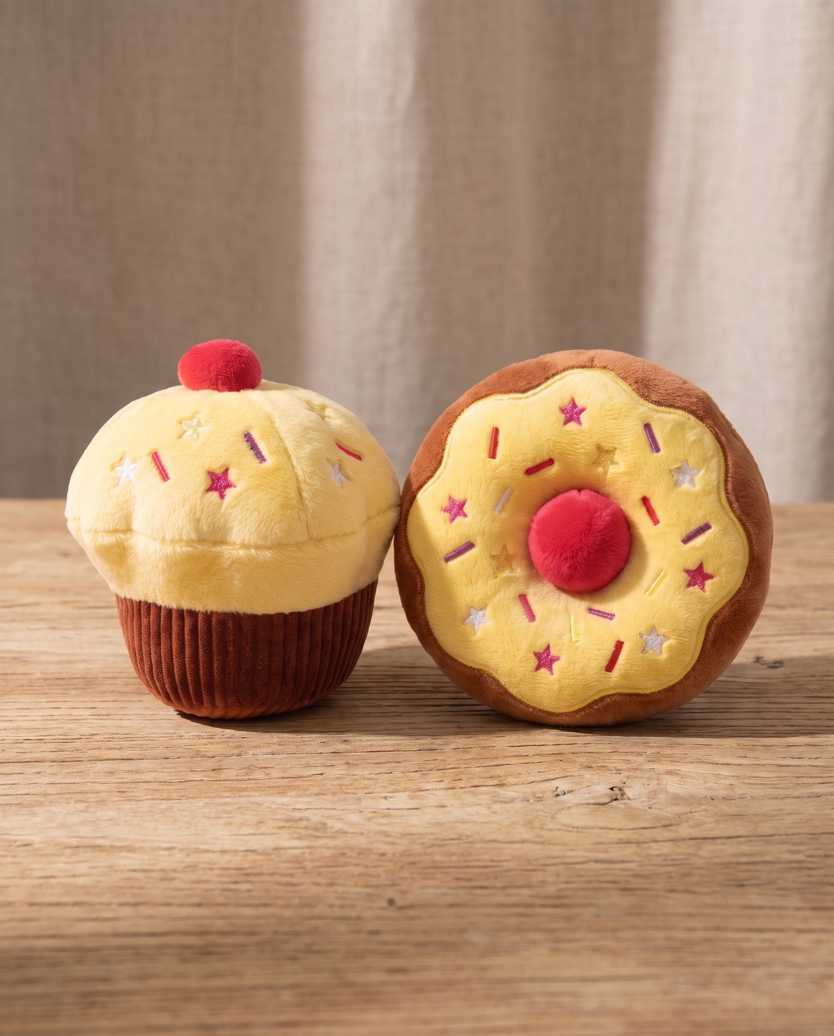 Squeaky Cupcake Plush Dog Toys, styled in a home setting