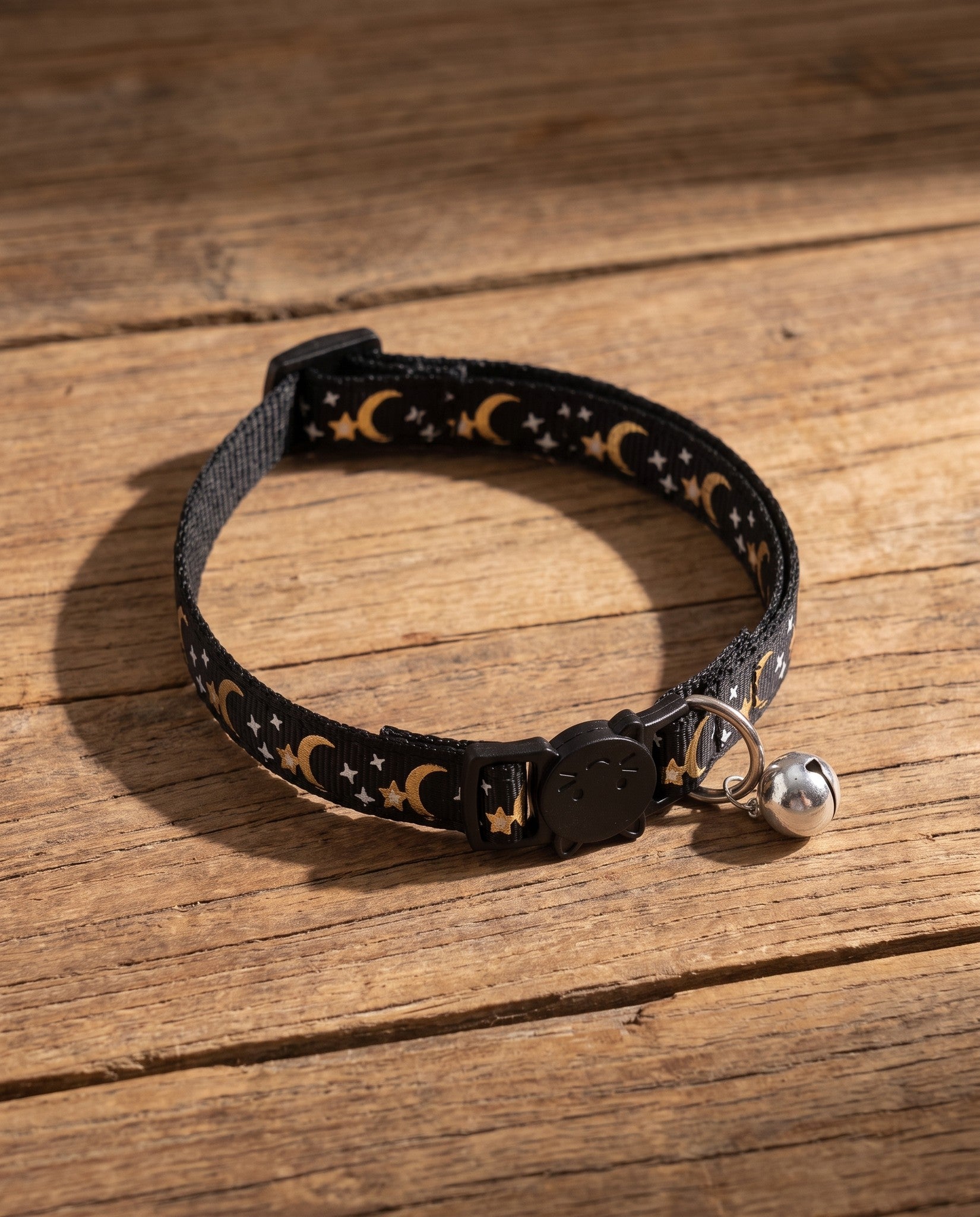 Star and Moon Cat Collar with Bell, styled in a home setting
