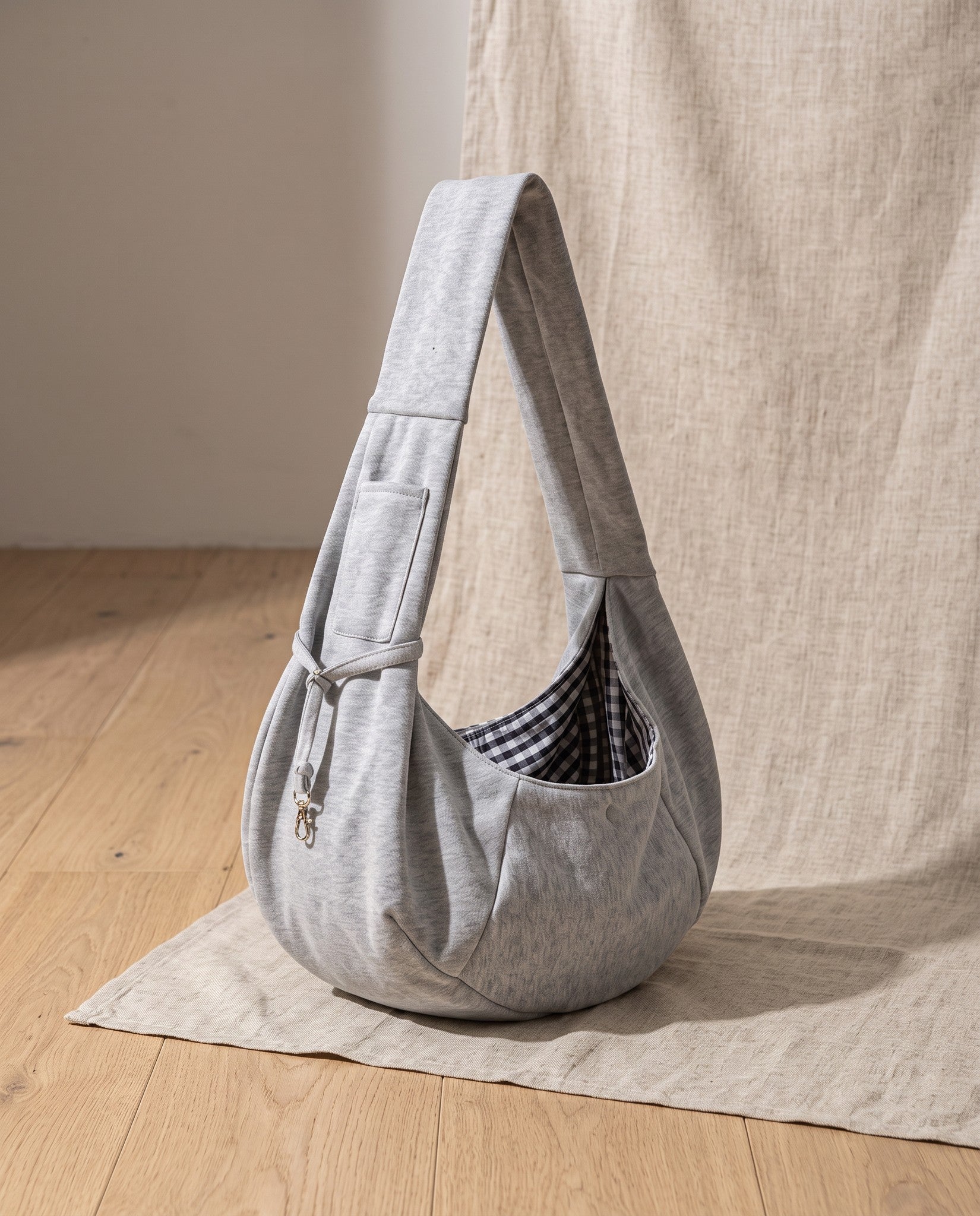 Cotton Sling Carrier with Storage Pockets, styled in a home setting