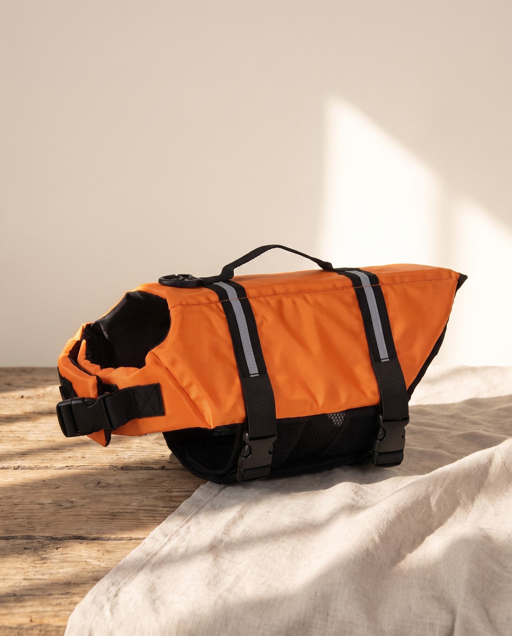 Reflective Dog Life Jacket with Lift Handle, styled in a home setting