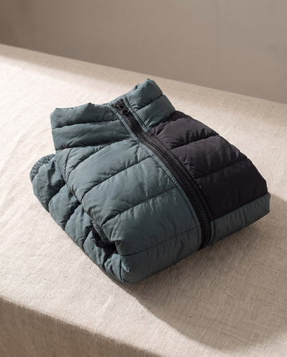 Padded Four-Leg Winter Dog Snowsuit, styled in a home setting