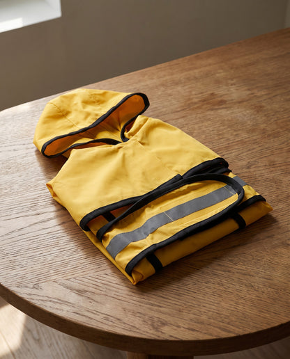 Hooded Waterproof Dog Raincoat, styled in a home setting