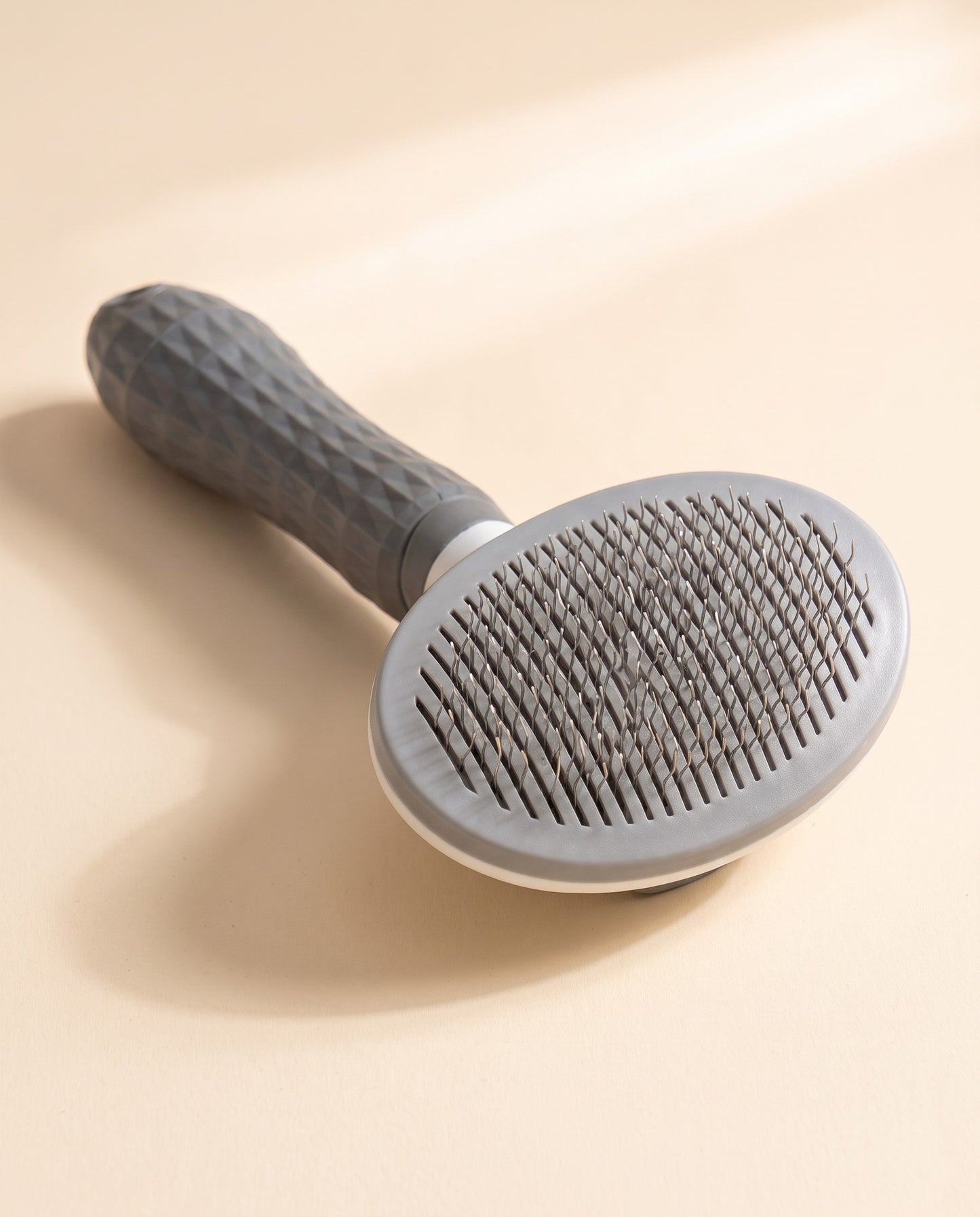 Self-Cleaning Slicker Brush, One-Click, styled in a home setting