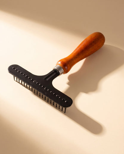 Wooden Handle Undercoat Rake, styled in a home setting