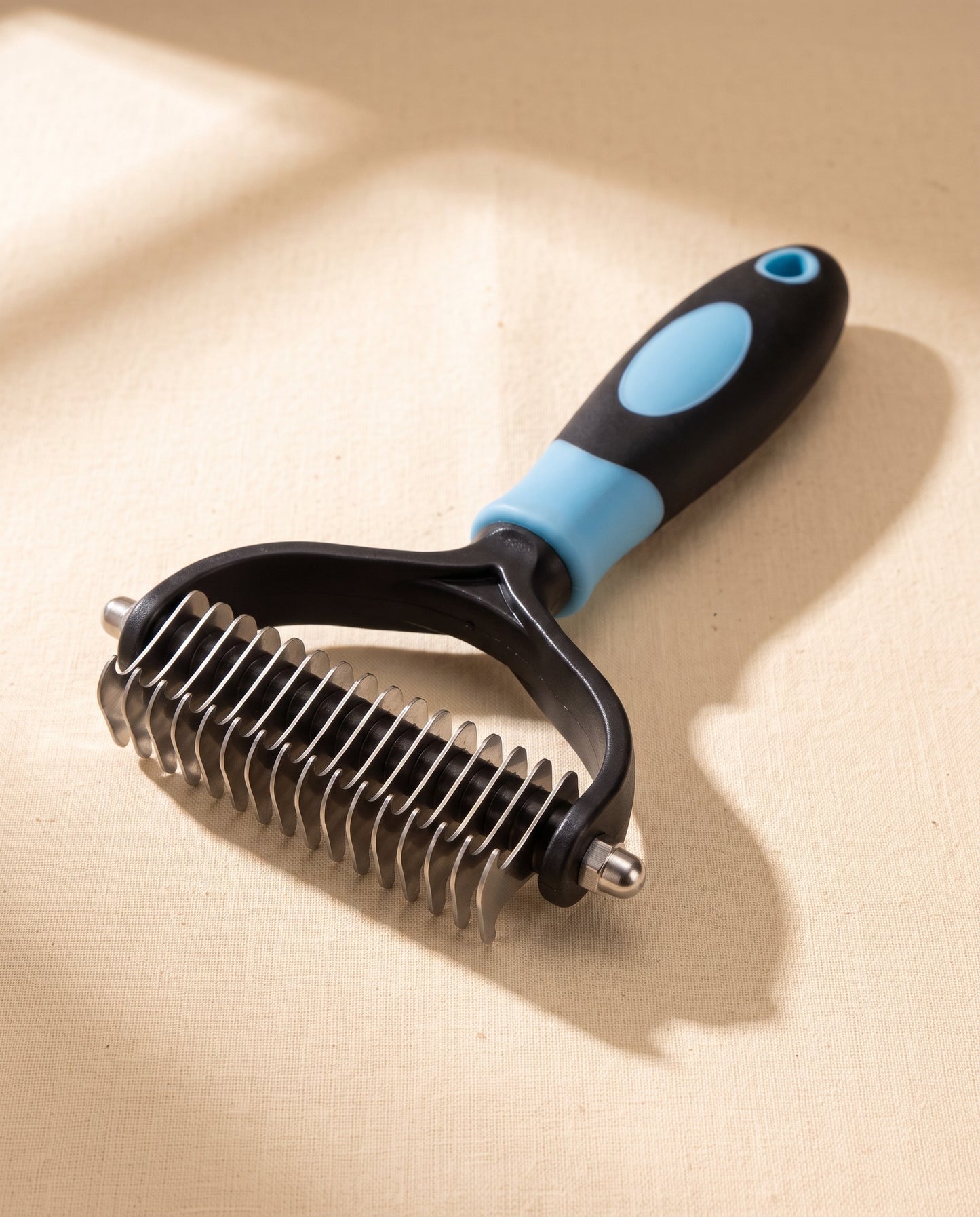 Two-Sided Dematting and Deshedding Rake, styled in a home setting
